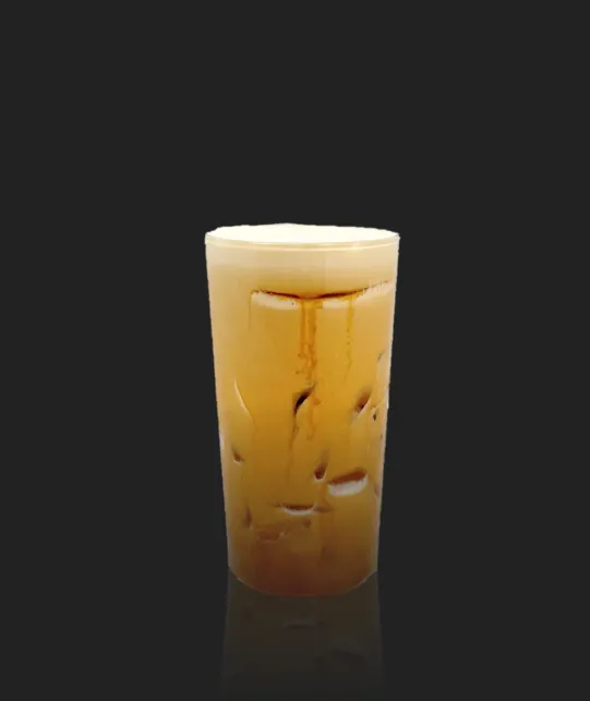 Tall glass of iced coffee with creamy swirls and ice, on a dark background.