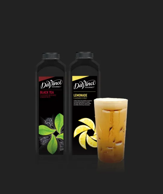 Two DaVinci Gourmet syrup bottles, Black Tea and Lemonade, with a glass of iced tea on a dark background.