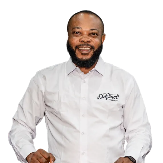 Portrait of a smiling man in a white button-down shirt with a DaVinci logo on the chest.