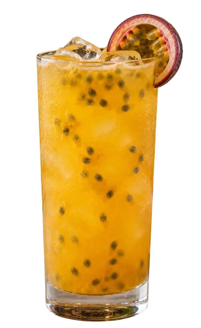 Tall glass of passion fruit juice with ice and black seeds, garnished with a halved passion fruit on the rim.